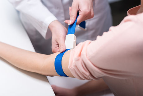 Healthcare worker preparing for blood draw — Dynacare Lab
