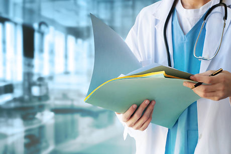 Doctor in white coat holding open a medical folder